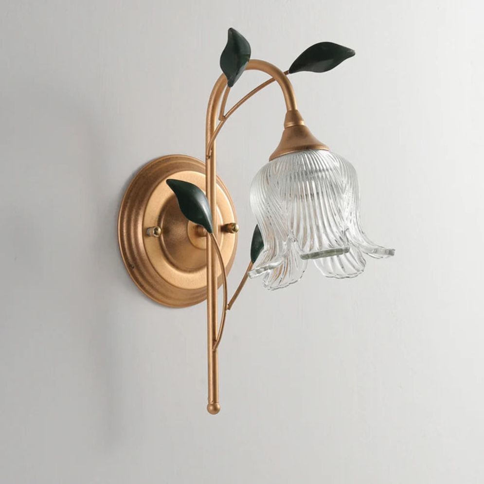 Golden wall light with glass ball shade casts a soft, elegant glow.