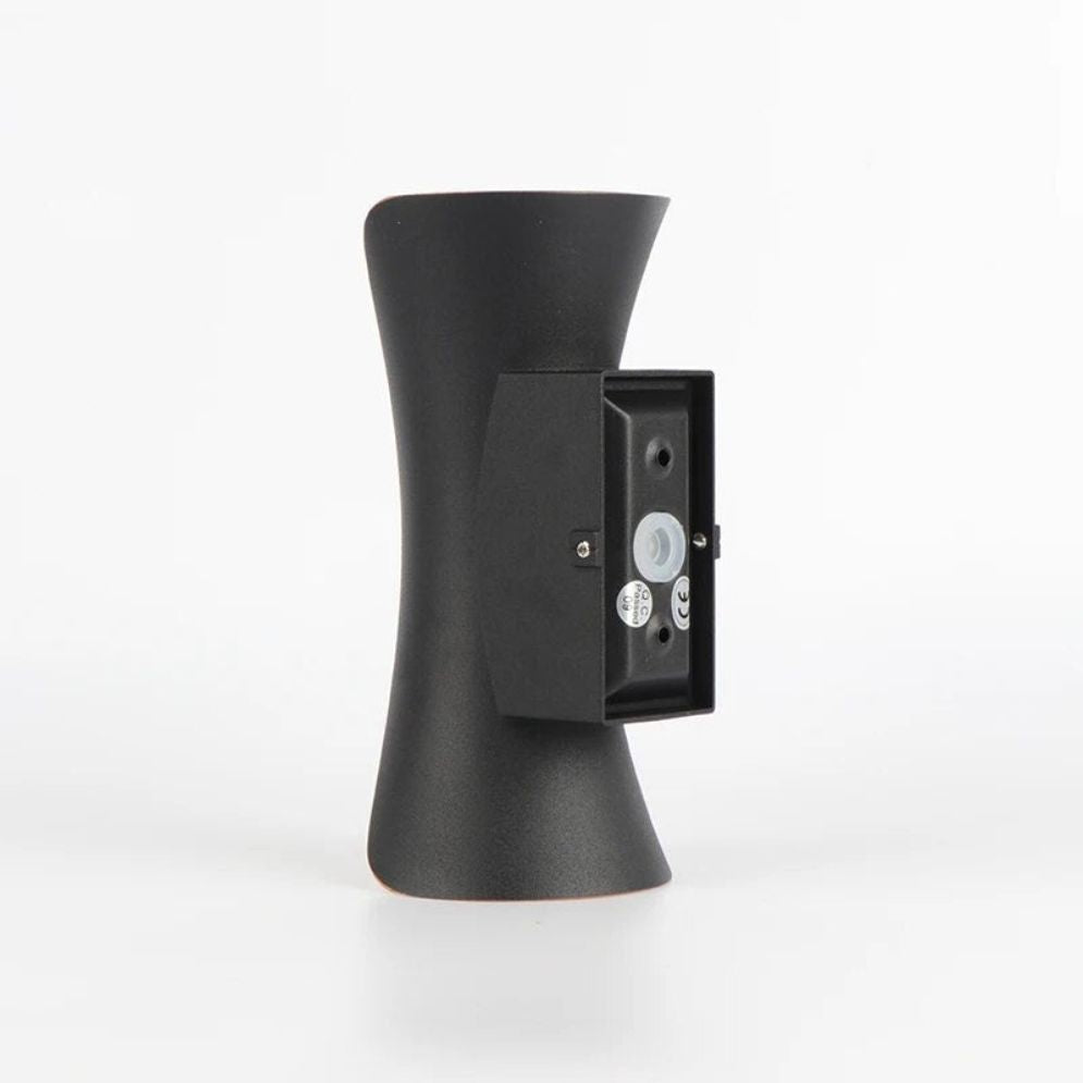 Modern black hourglass LED wall light adds sleek, efficient illumination to any space.