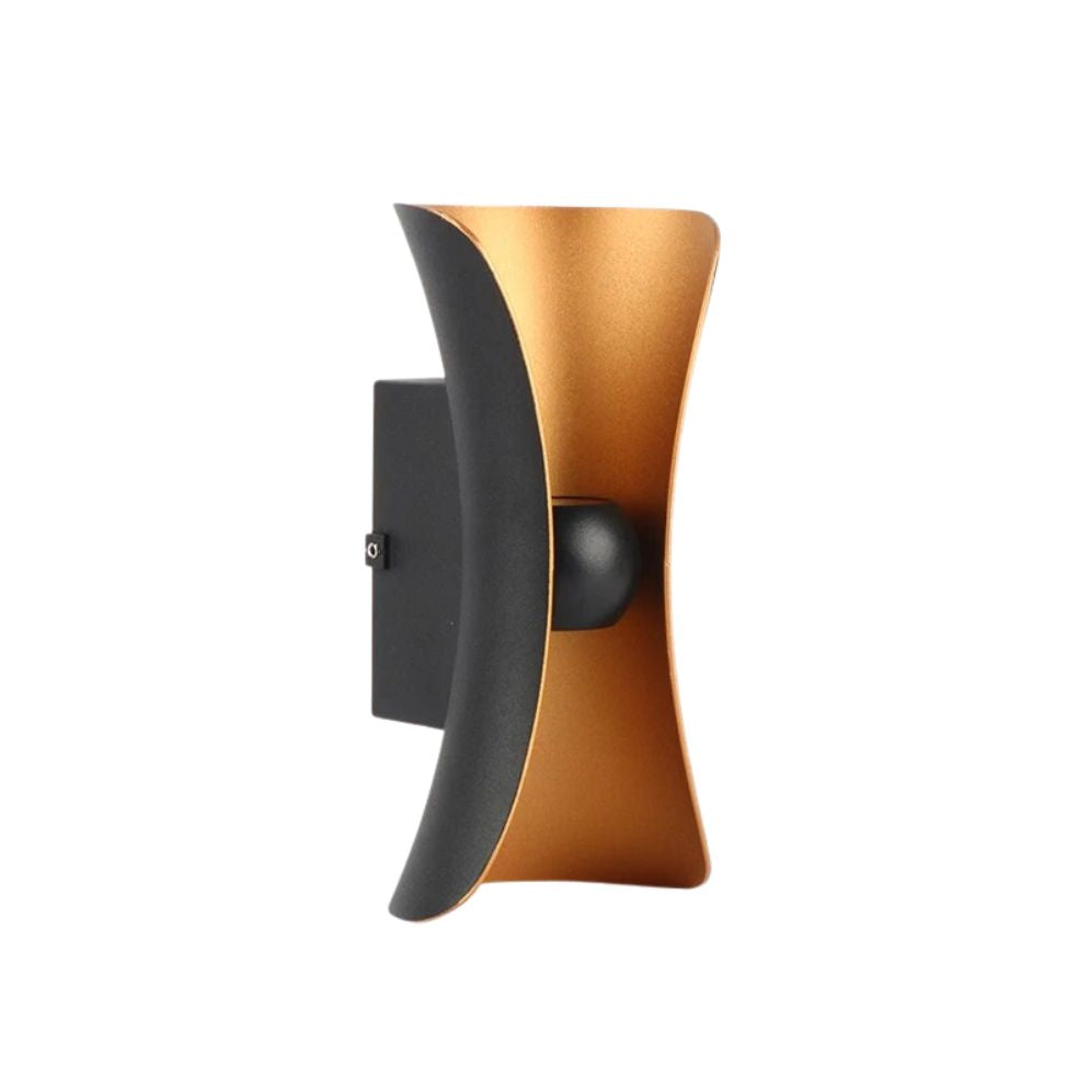 Bold black and gold hourglass-shaped LED wall light emits sleek, modern illumination.