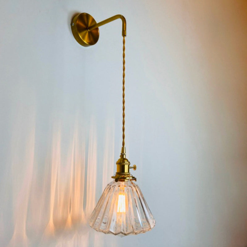 Warm, gentle light glows from a fluted glass shade, casting delicate, soft shadows.