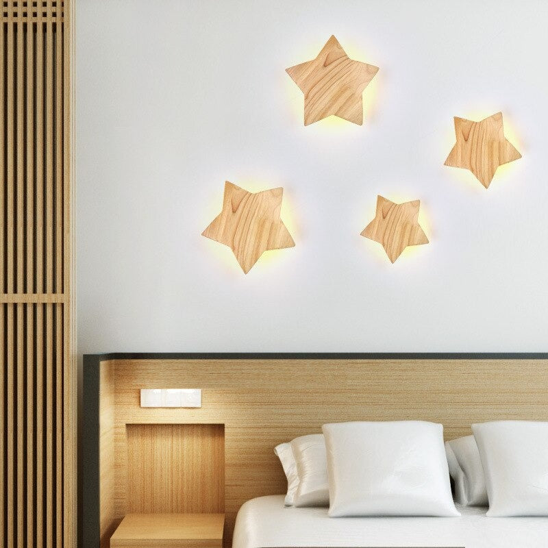 Four glowing ORLUNE HOME Wooden Star Wall Lights create a warm, modern ambiance.
