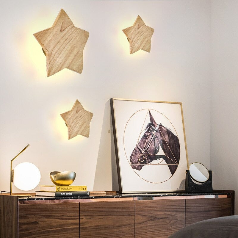 Three wooden star wall lights glow gently, creating cozy accent lighting for any room.