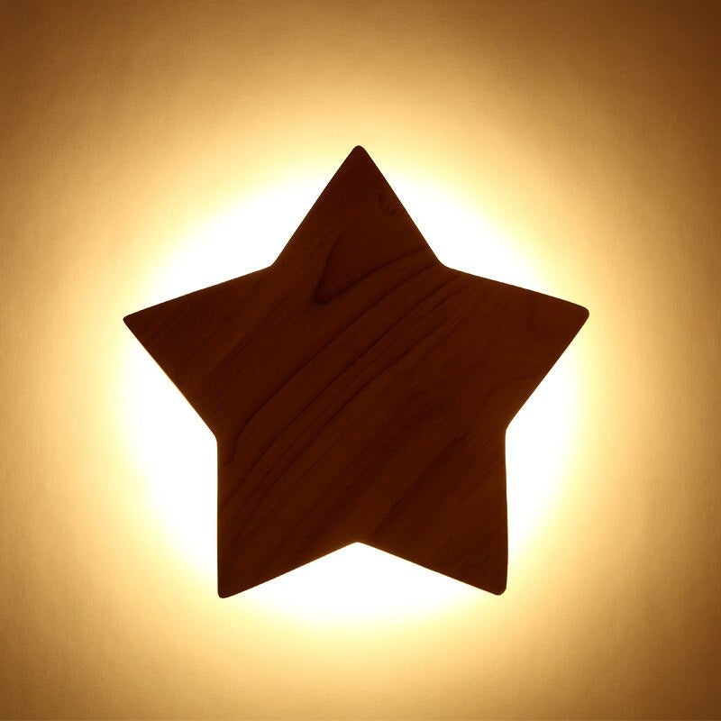 This star wall light bathes the room in a gentle, cozy yellow glow.