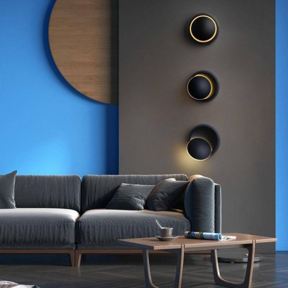 Three ORLUNE HOME LED Colored Disk Industrial Wall Lights create striking vertical illumination.