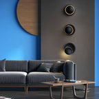 Three ORLUNE HOME LED Colored Disk Industrial Wall Lights create striking vertical illumination.