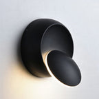Soft, diffused glow from a tilting black disc creates stylish, modern ambient lighting.