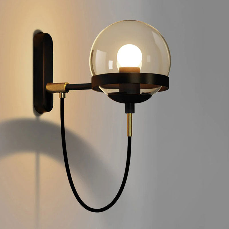 Illuminate your room with stylish, modern light from this glass globe wall sconce.