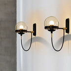 Modern glass ball wall lights emit gentle illumination with moody, artistic shadow play.