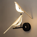 Experience soft, inviting light enhanced by golden bird accents and modern minimalist design.