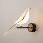 Soft lighting radiates from the golden bird wall light, creating a warm, modern glow.