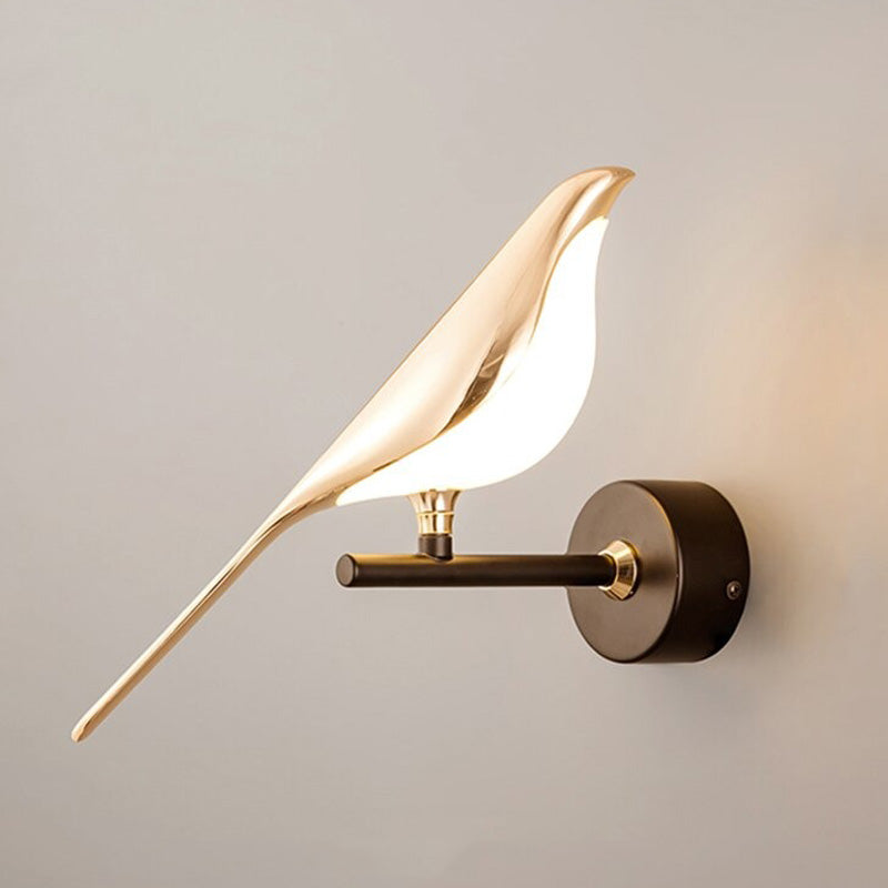 Soft lighting radiates from the golden bird wall light, creating a warm, modern glow.