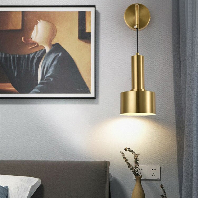 The ORLUNE HOME Gold Wall Lamp emits a warm, focused glow from its cylindrical shade.