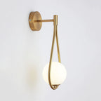 The LED wall light provides soft, elegant illumination with its brass base and frosted globe.