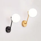 Elegant moon-inspired wall lights, in black and gold, emit a soft atmospheric glow.