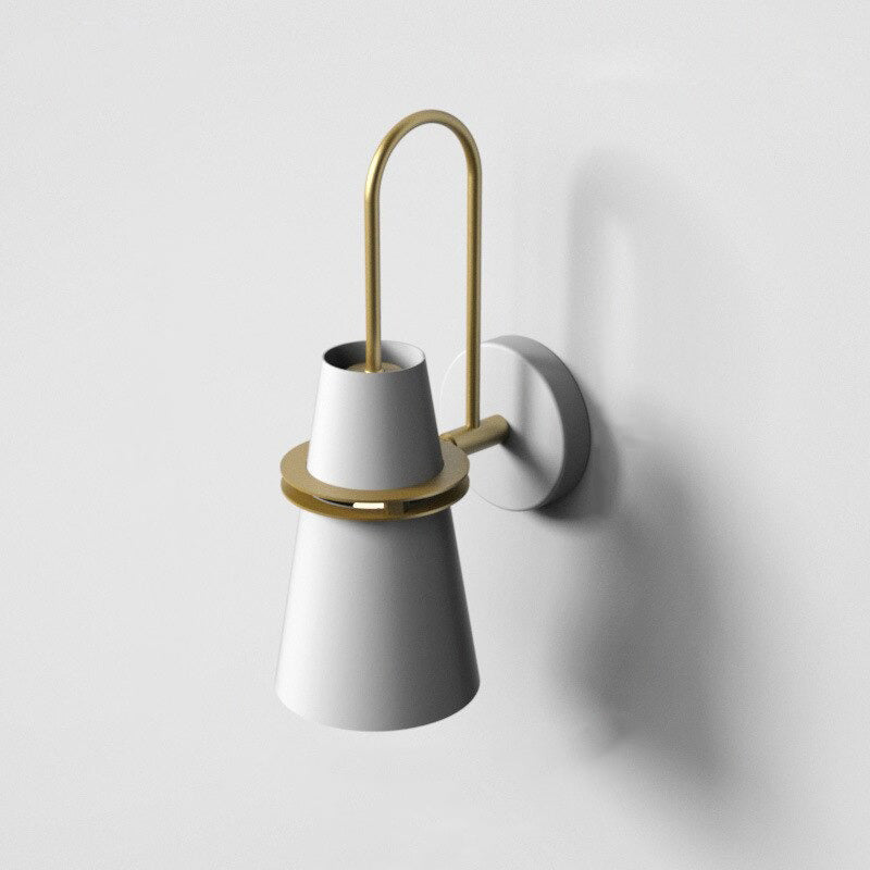 Soft LED glow radiates from a stylish white and gold modern wall light fixture.