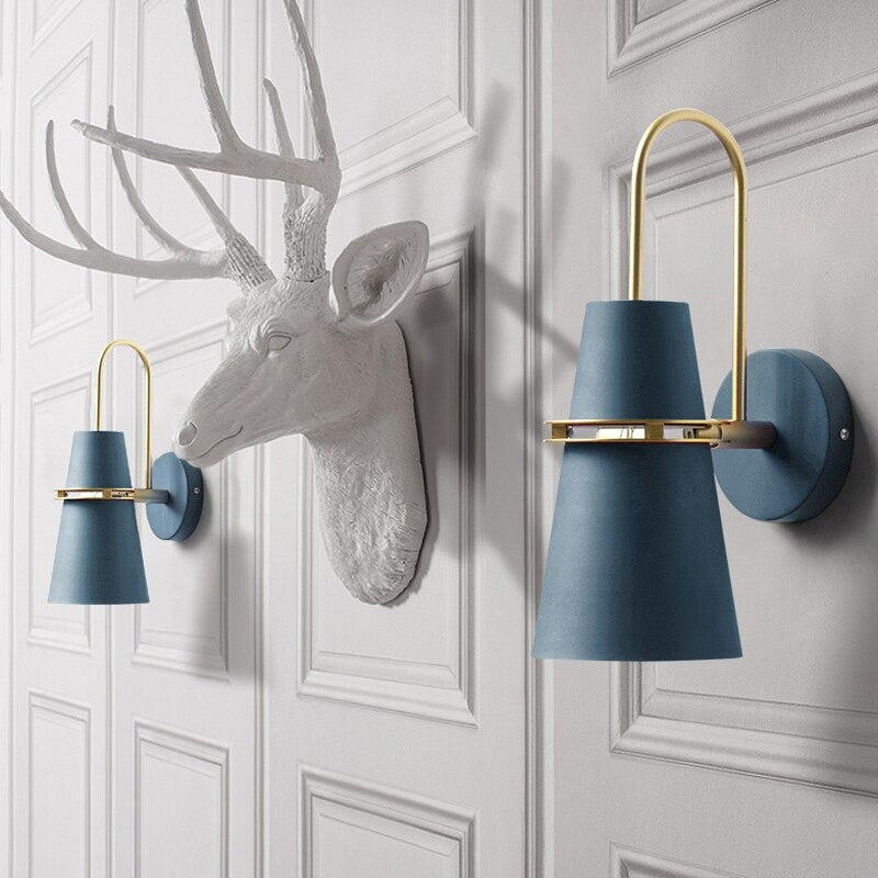 Blue and gold cone-shaped LED wall lights add modern Nordic flair to the space.