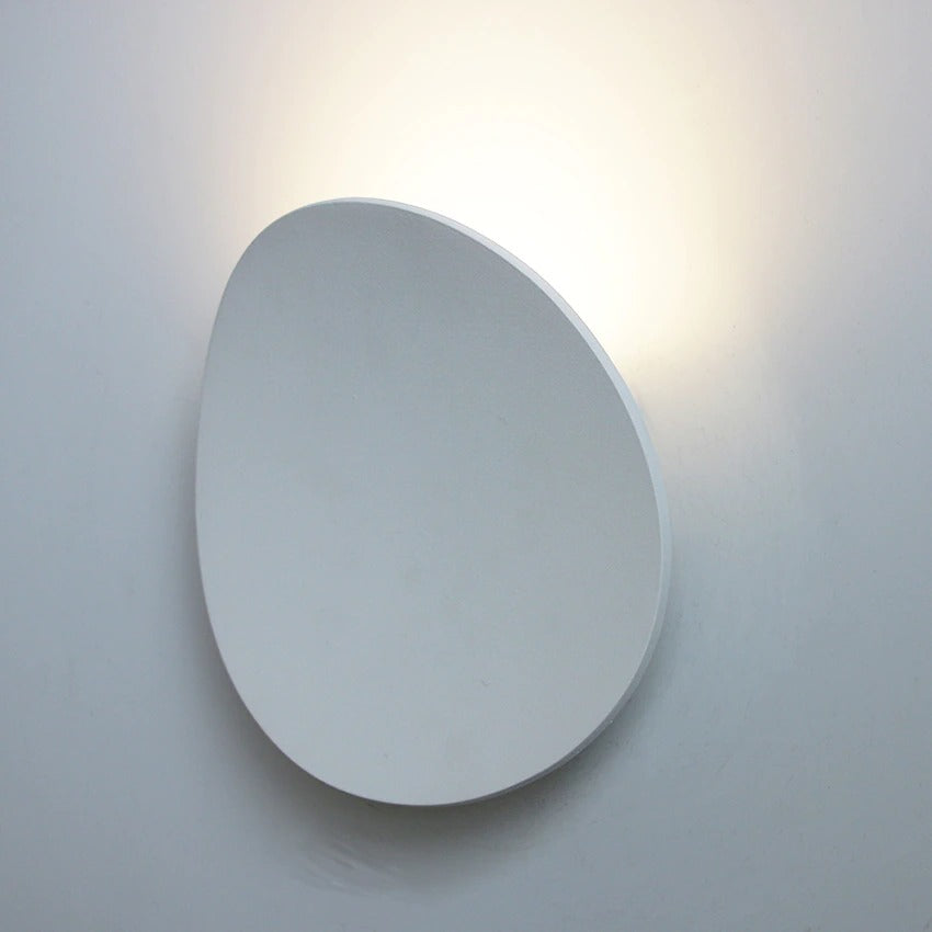 Minimalist circular LED light softly glows, creating a subtle and elegant kitchen ambiance.