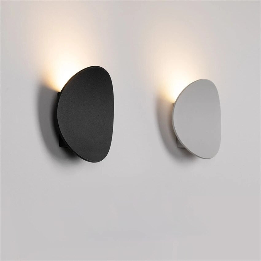 Soft upward glow from black and white LED circles sets a modern lighting vibe.