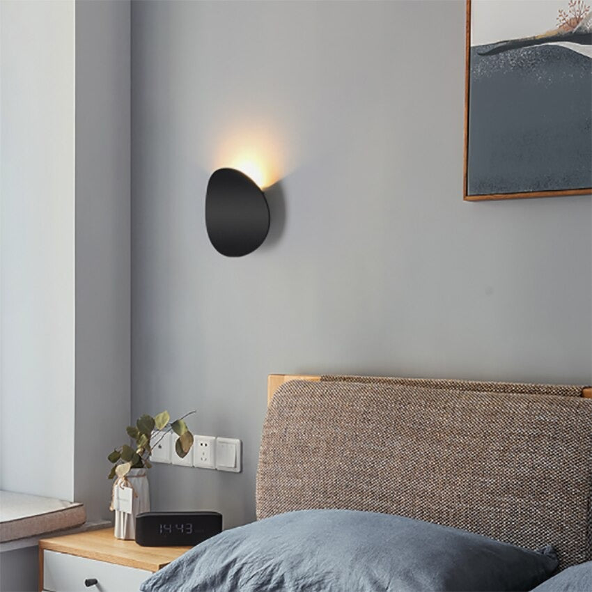 The ORLUNE HOME circular LED wall light emits a warm, modern glow on the wall.