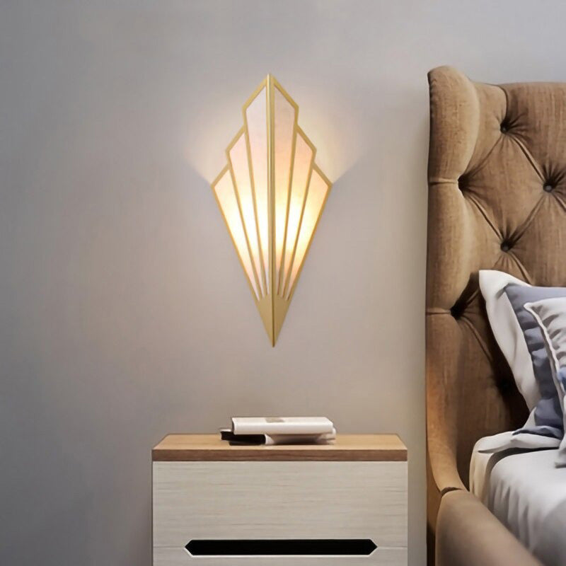 The ORLUNE HOME Wall Light emits a soft, warm glow with elegant black and gold tones.
