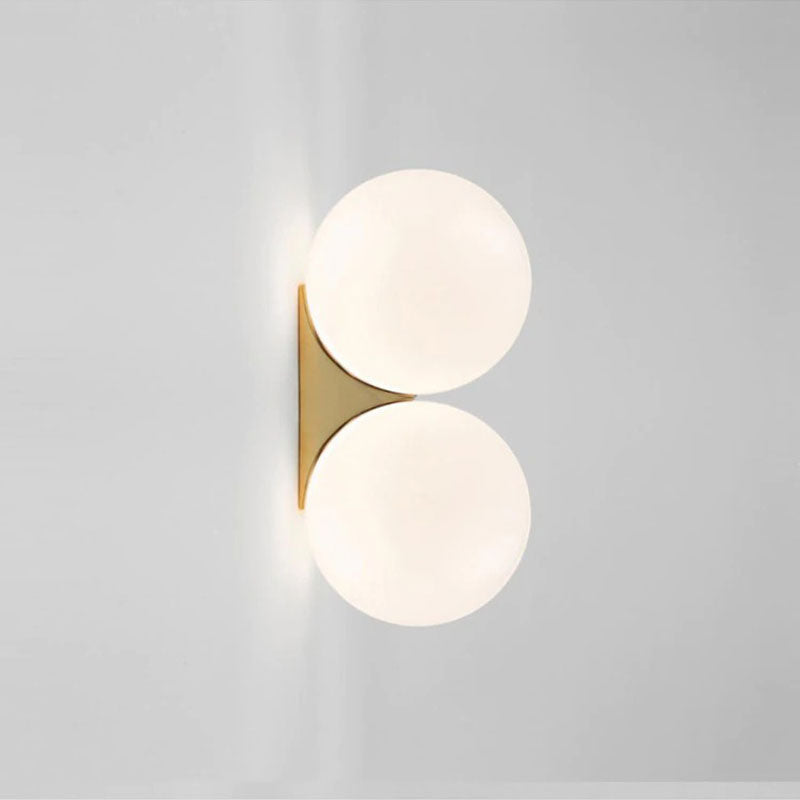 Two globe lights on a gold base offer elegant, minimalist illumination for any kitchen.