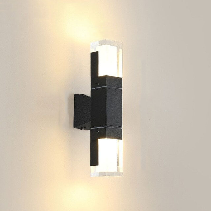 Warm LED light glows from both ends of this modern black wall-mounted fixture.