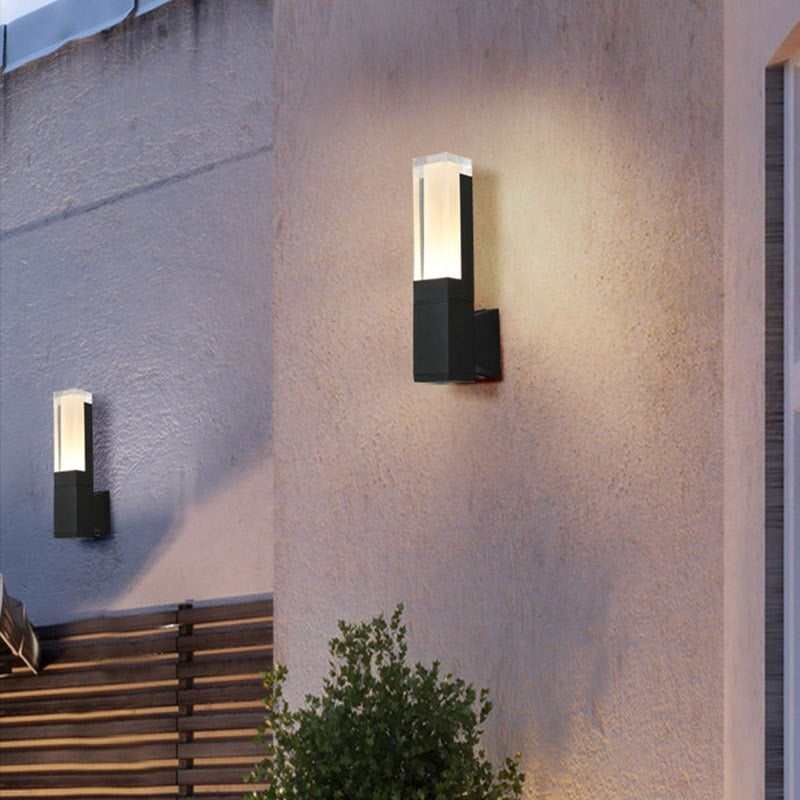 The LED Wall Light casts a bright, motion-activated glow against the textured wall at dusk.