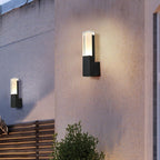 The LED Wall Light casts a bright, motion-activated glow against the textured wall at dusk.