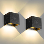 Soft warm LED light shines upward and downward, crafting geometric patterns on walls.