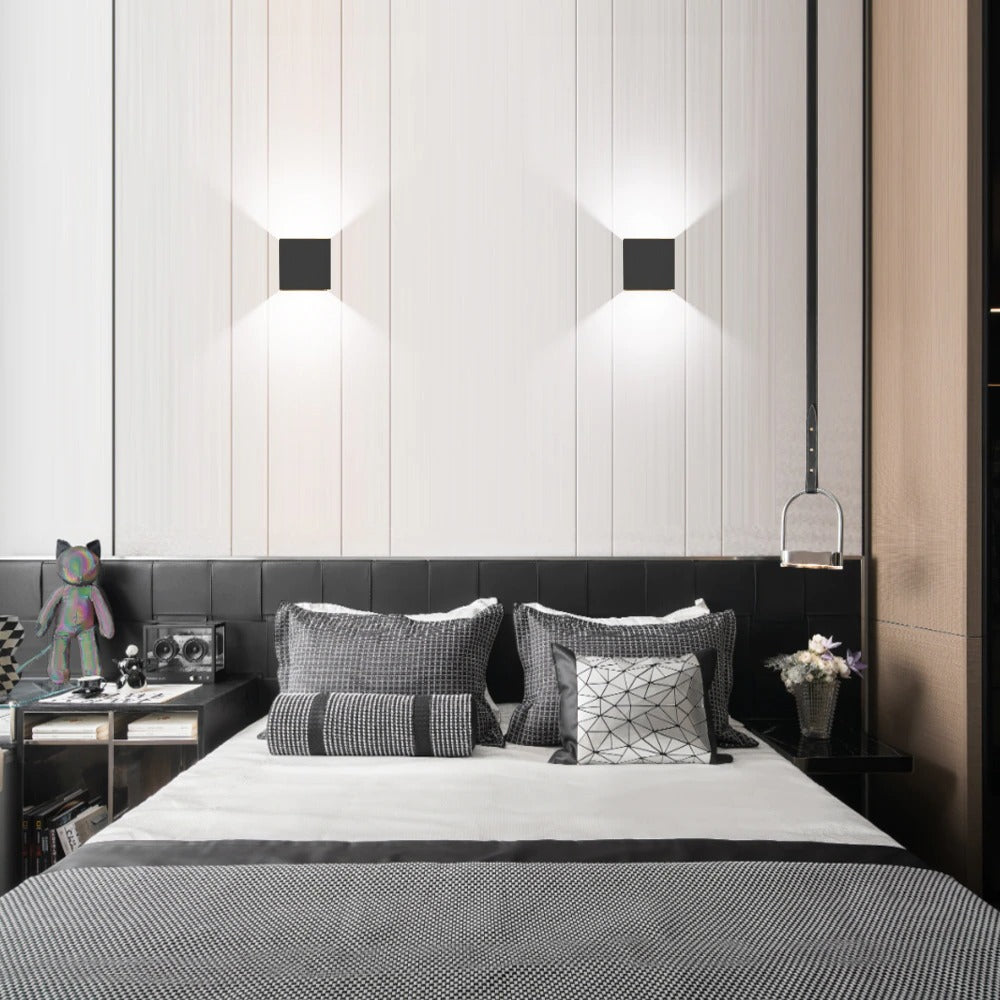 The ORLUNE HOME LED Cube Wall Light casts chic, geometric illumination in this bedroom.