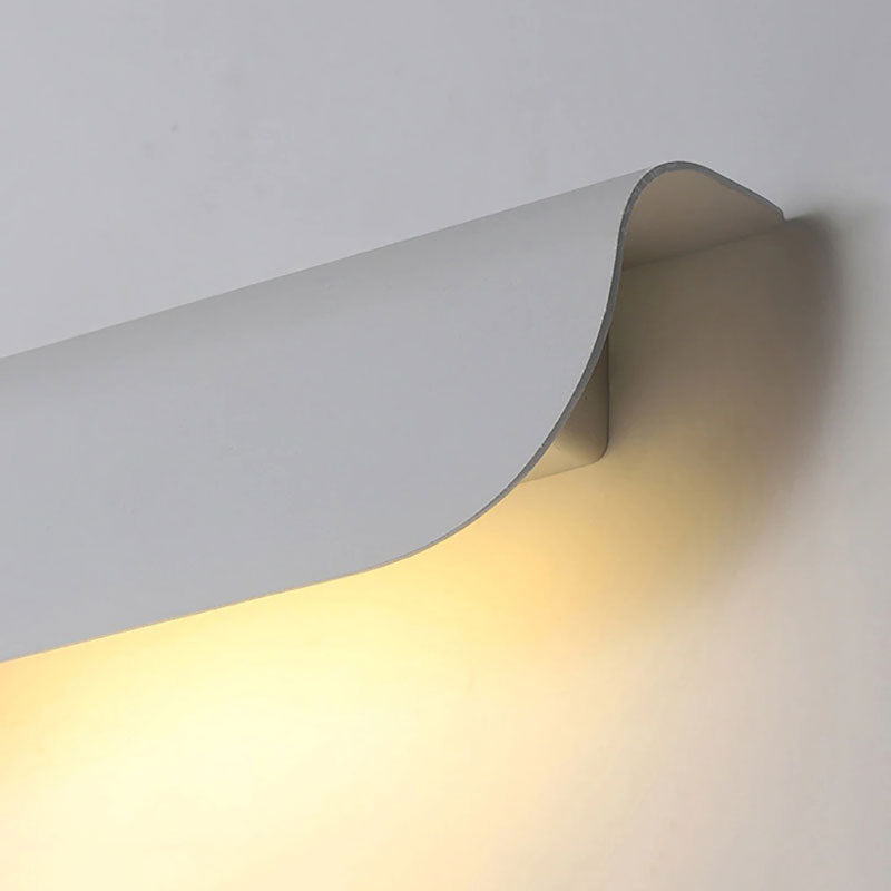 Soft, warm LED glow illuminates walls with a wave-like light pattern.
