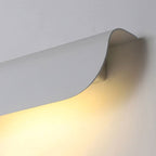 Soft, warm LED glow illuminates walls with a wave-like light pattern.