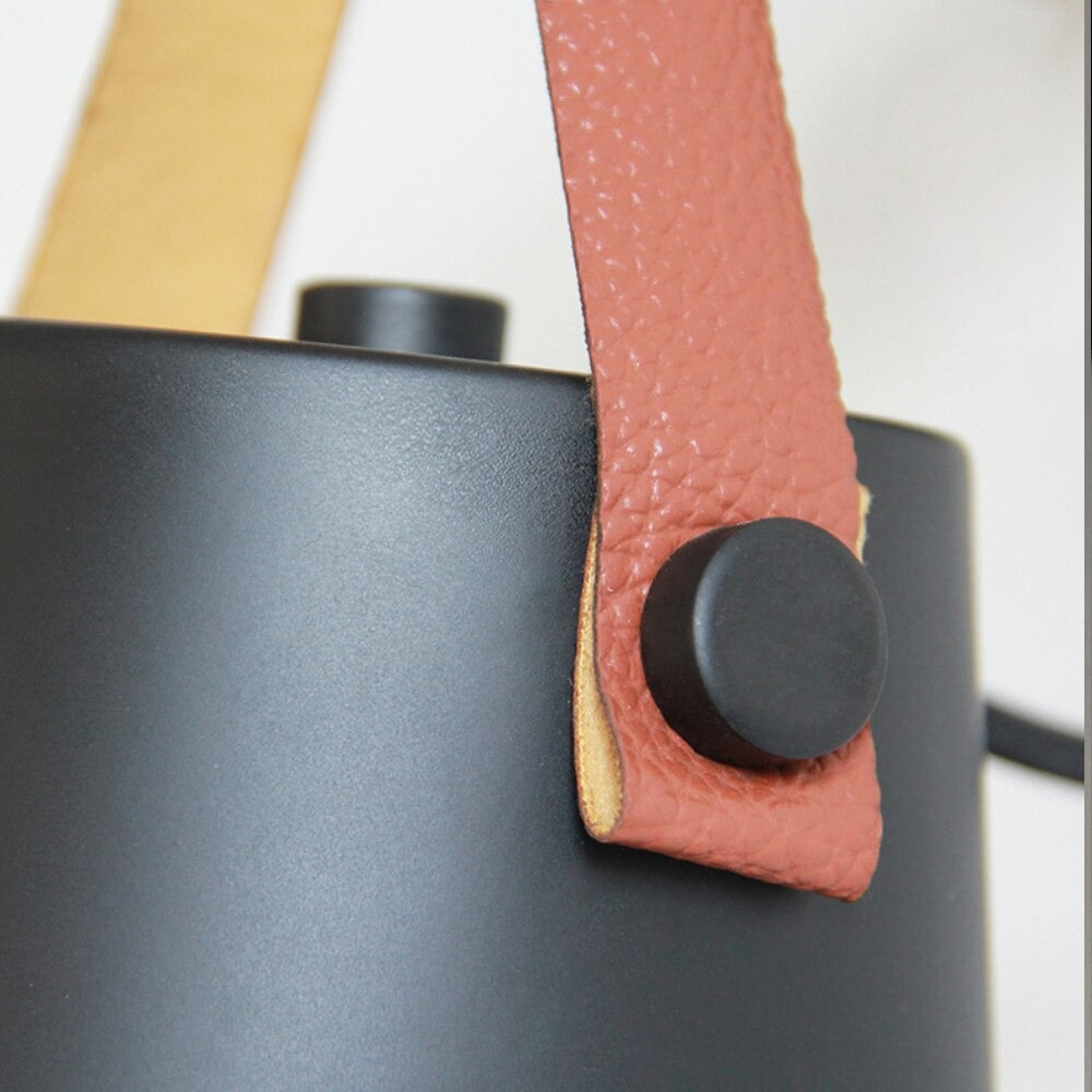 Warm, focused light from matte black Nordic wall lamp sets a cozy ambiance.