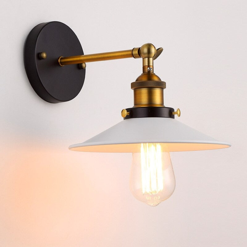 Retro wall light with black and brass design, cone shade, vintage bulb—timeless illumination.
