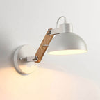 Bright, adjustable wall-mounted lamp shines warm, focused light from its white metal shade.