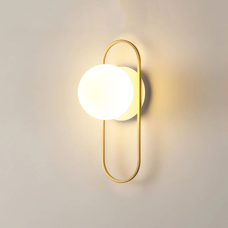 This LED wall light offers warm, elegant illumination with its glowing globe and gold accents.