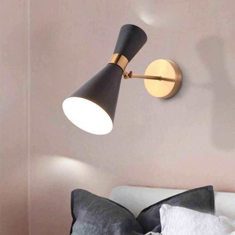 The Black Chrome LED Wall Light casts a soft, warm indoor glow on the wall.