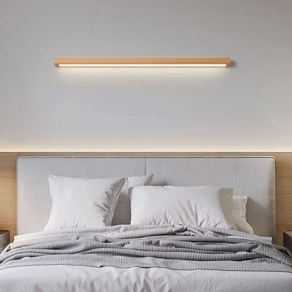 The ORLUNE HOME LED Wall Light casts a warm, inviting glow in the minimalist room.