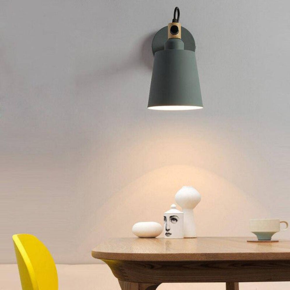Warm glow from an adjustable retro sconce creates inviting, focused ambiance on the wall.