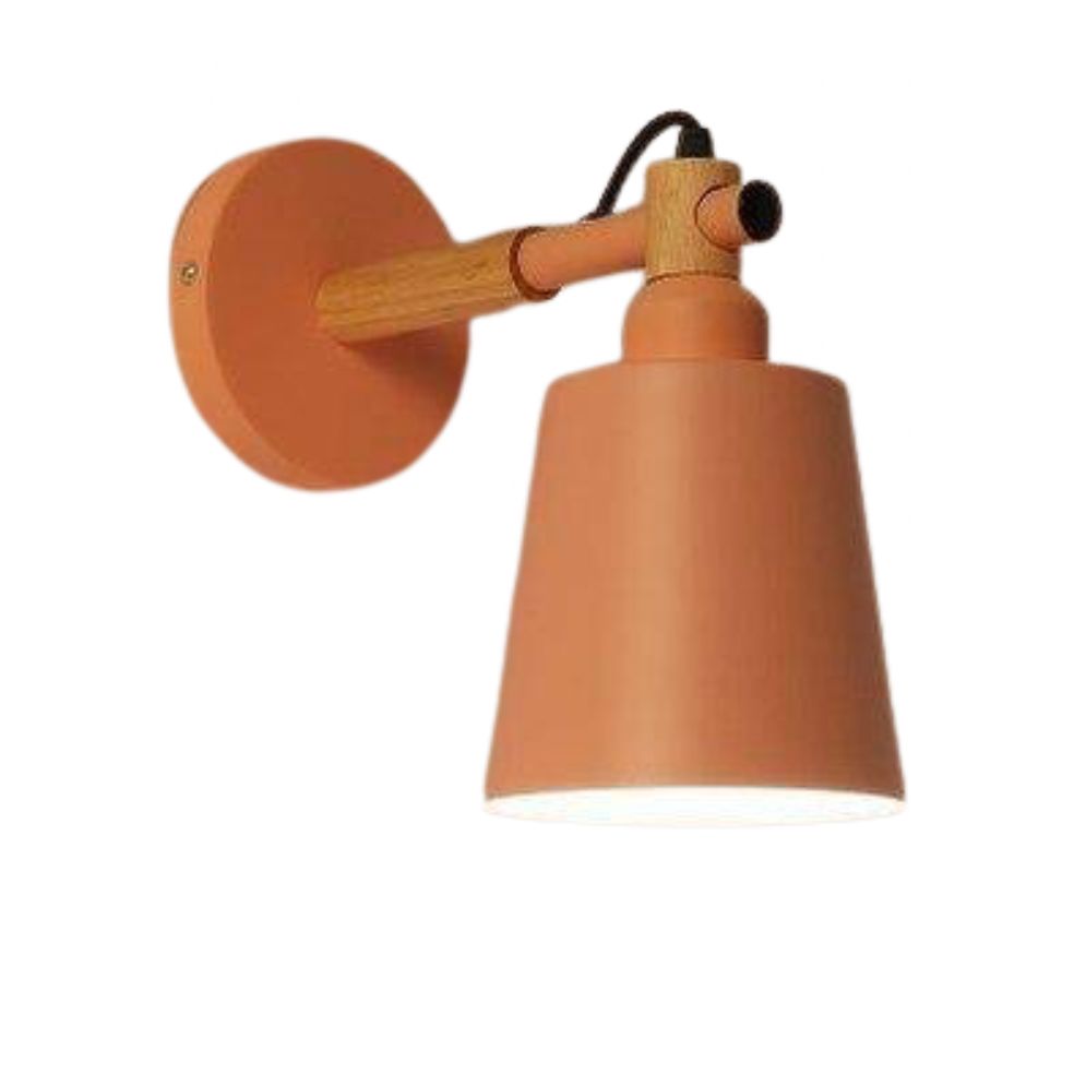 Warm, focused downward light beams from the matte orange conical shade and wooden arm.