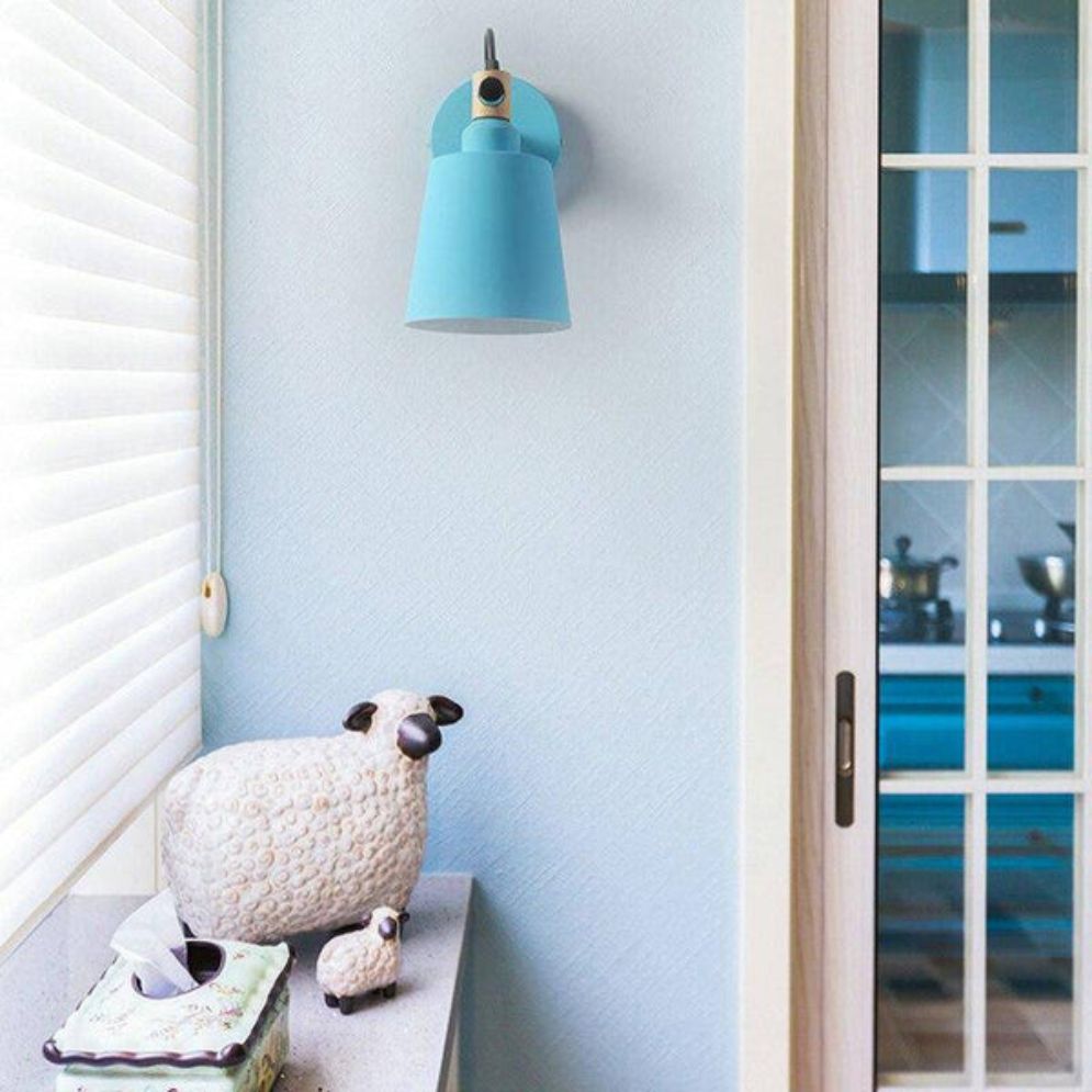 A stylish light blue retro sconce brightens the kitchen area with adjustable LED illumination.