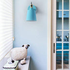 A stylish light blue retro sconce brightens the kitchen area with adjustable LED illumination.