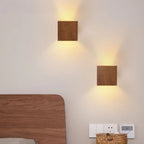 Warm, up-and-down LED lighting creates a soft, inviting glow on the beige wall.