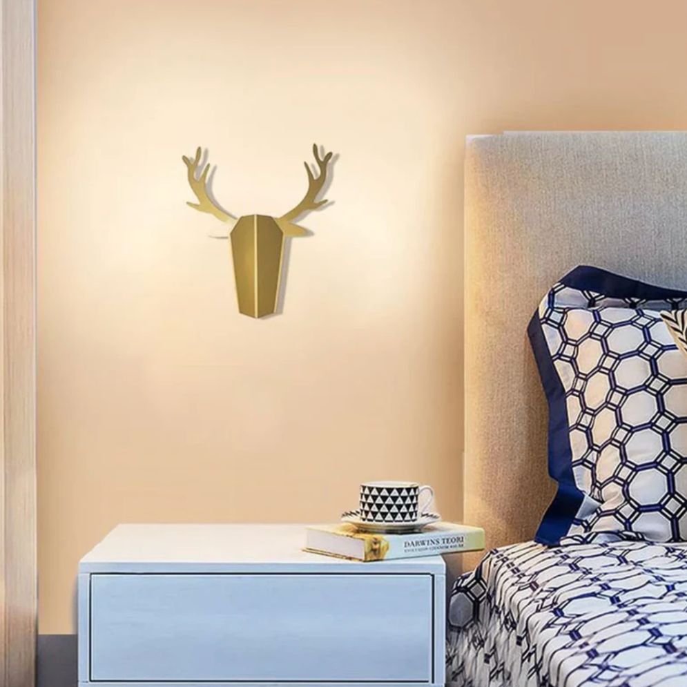 Gold geometric deer head art glows with a stylish ORLUNE HOME LED wall light.