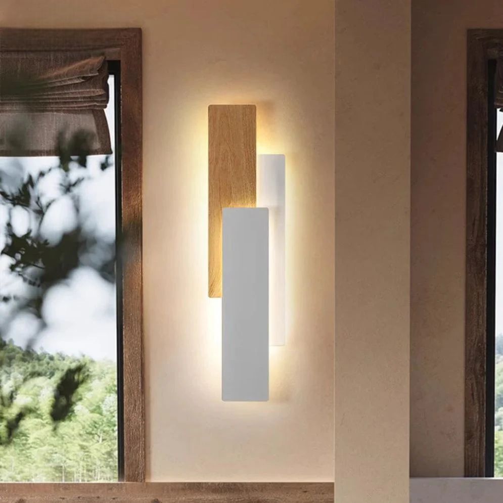 Soft, dimmable warm light glows from overlapping wood and white panels on the wall.