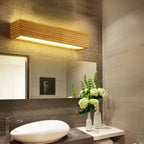 The Japanese Design LED wall light casts a soft, elegant glow above the mirror.