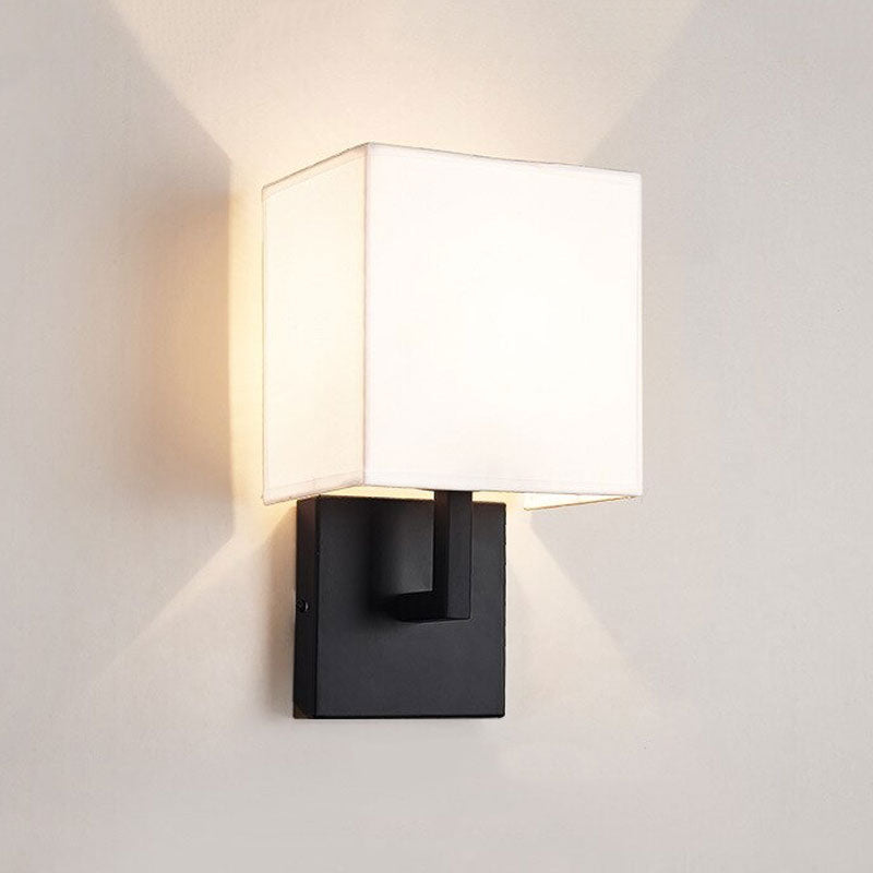 This wall light casts a warm, inviting glow with modern elegance and soft illumination.