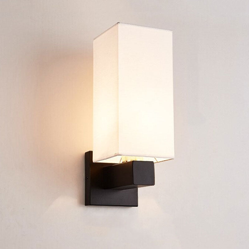 Soft accent lighting glows from a modern black base with a rectangular white shade.