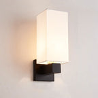 Soft accent lighting glows from a modern black base with a rectangular white shade.