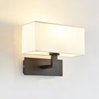 Soft, warm illumination shines from the sleek, rectangular-shaded ORLUNE HOME wall light.